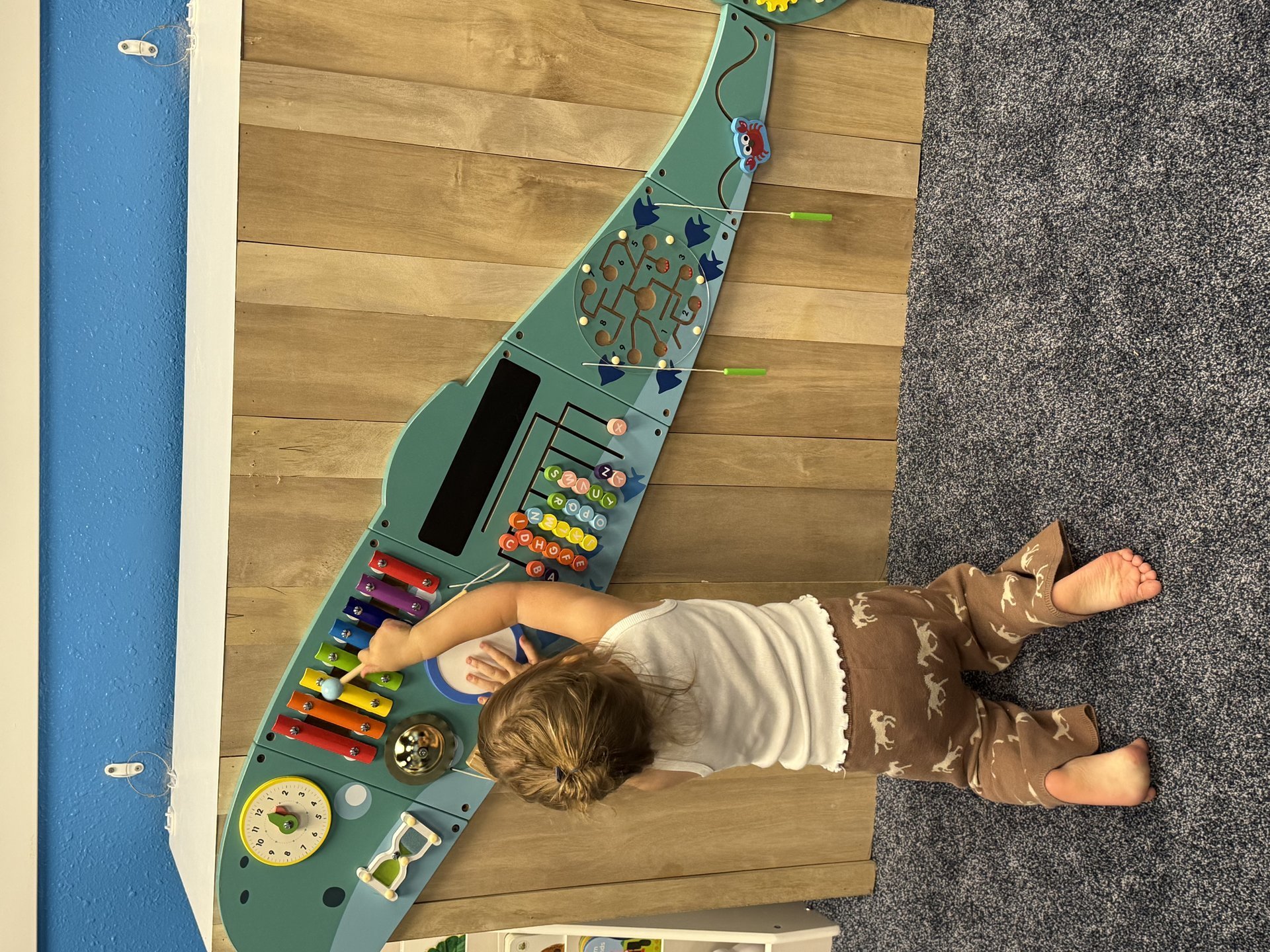 Child playing on climbing wall