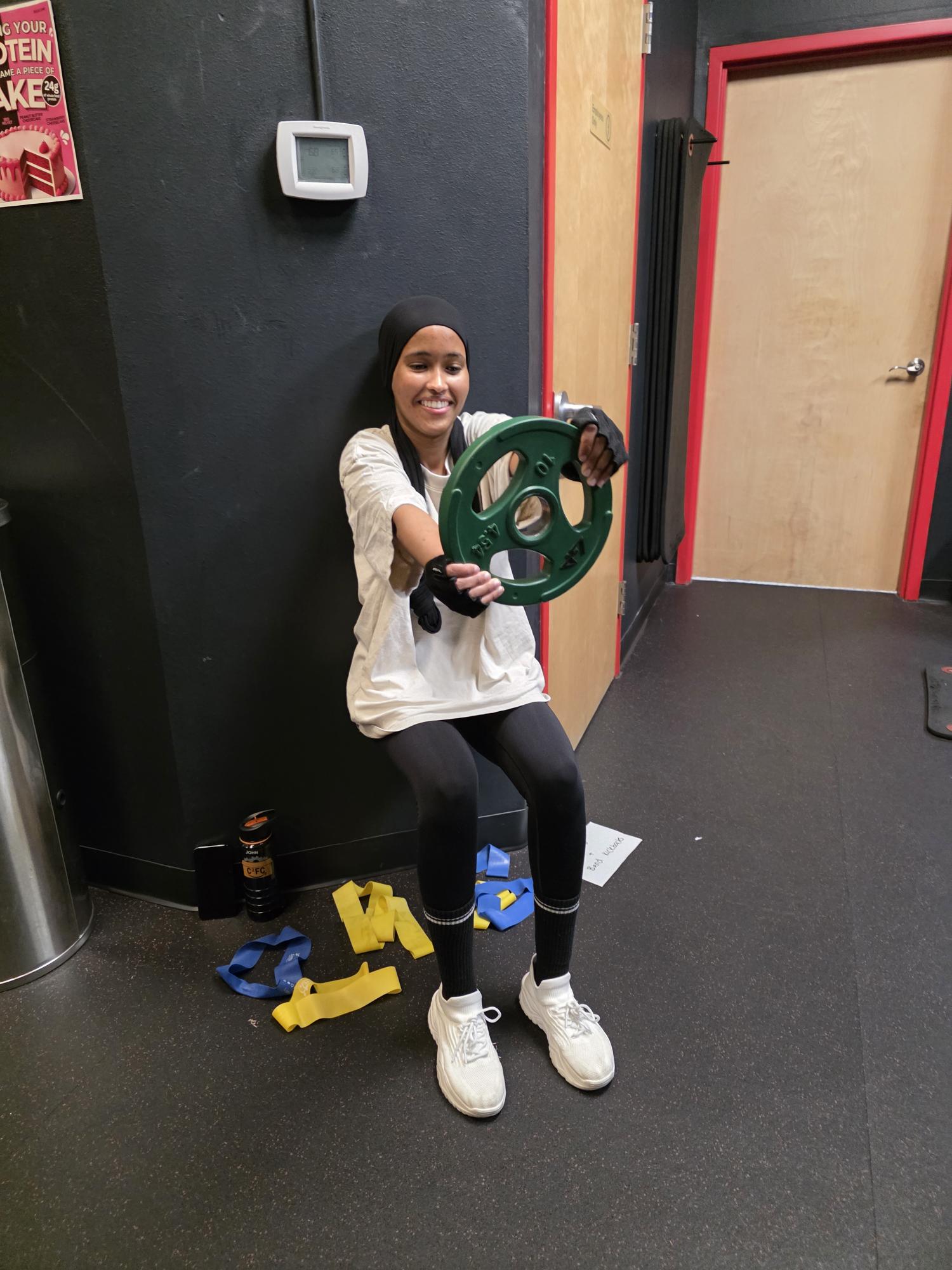 Girl wall sitting with weight