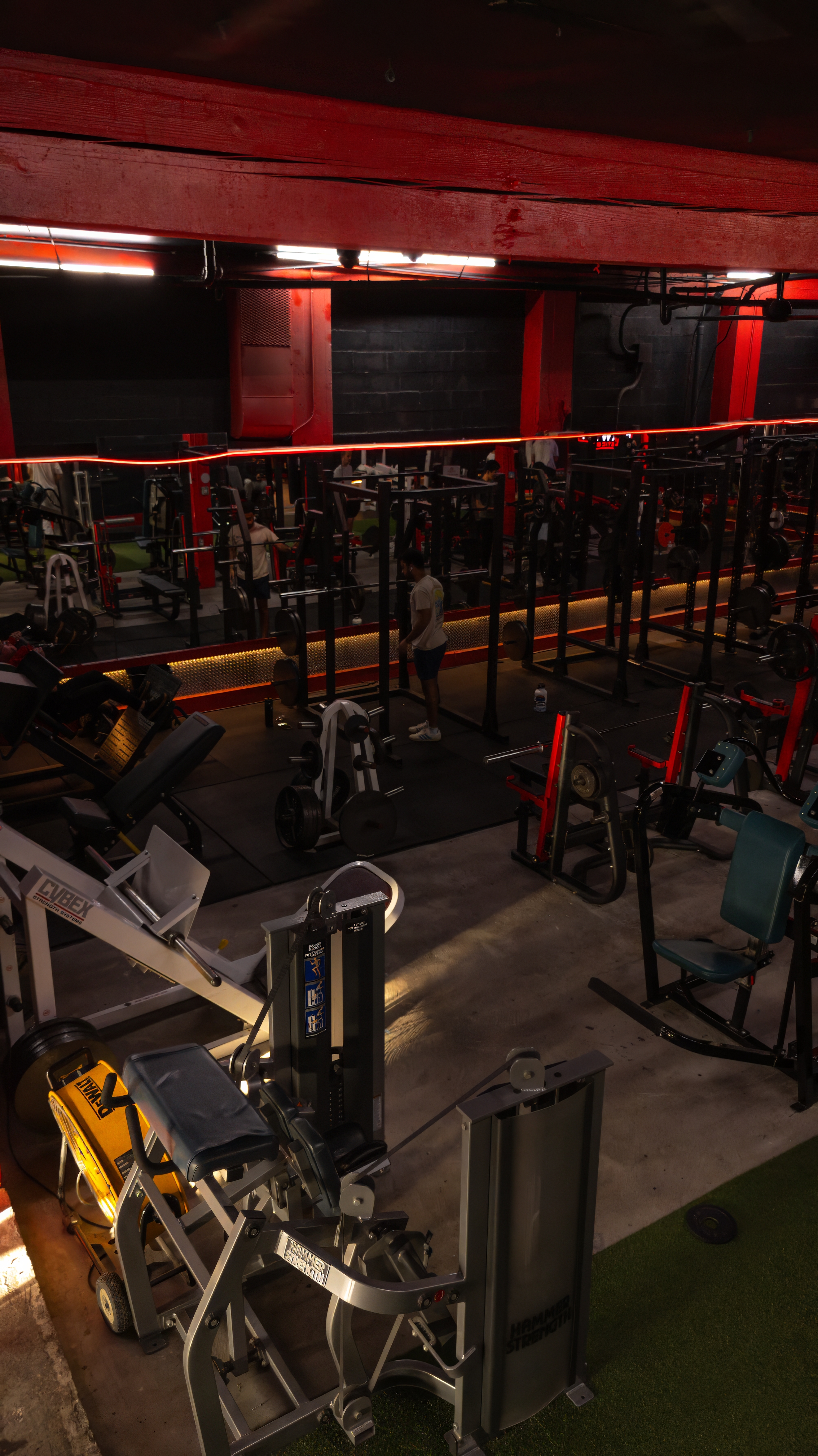 Full array of heavy lifting and strength training machines in the gym, including leg presses and Hammer Strength equipment