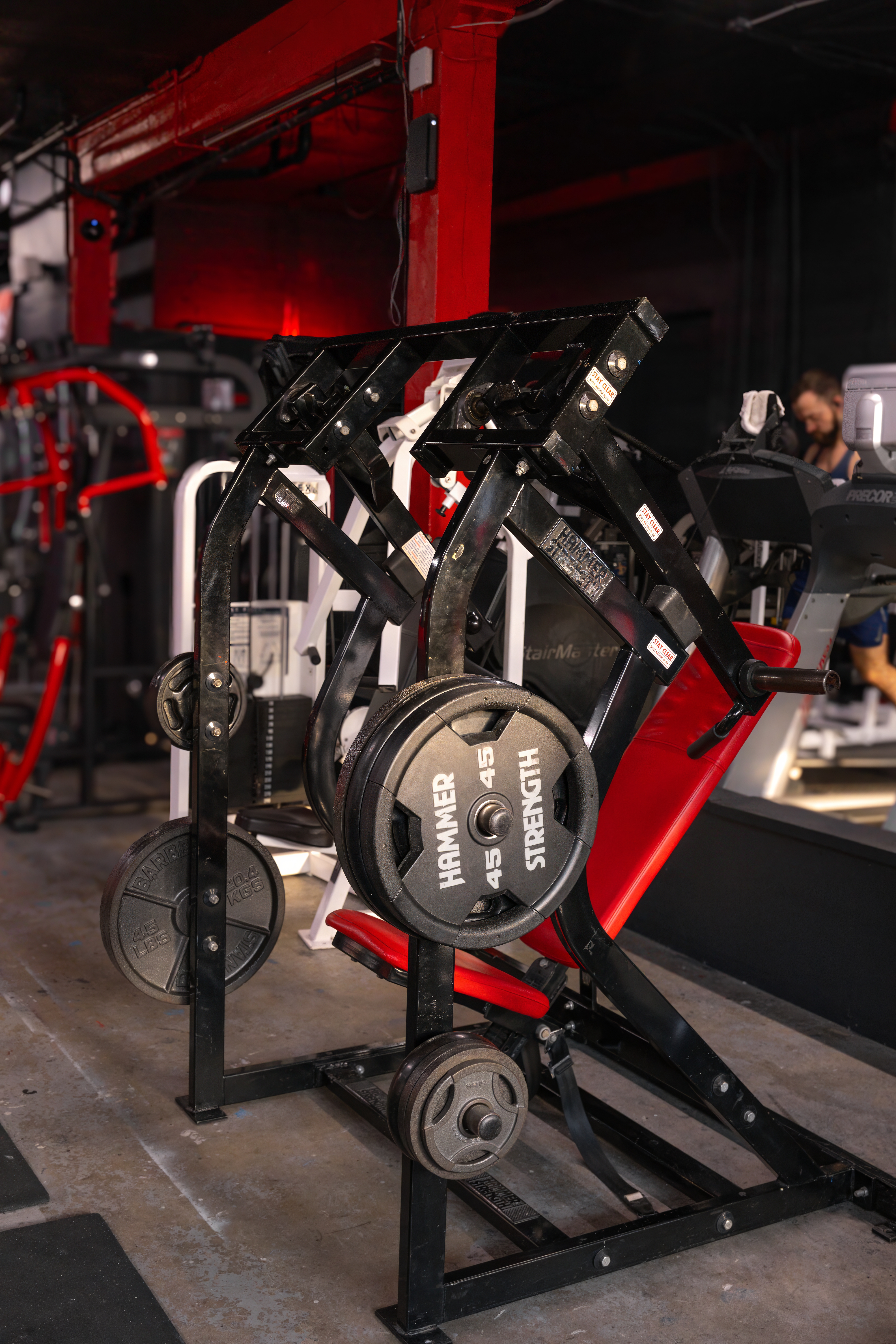 Plate-loaded specialized back machine, featuring a Hammer Strength design and large 45lb plates, ready for heavy lifting