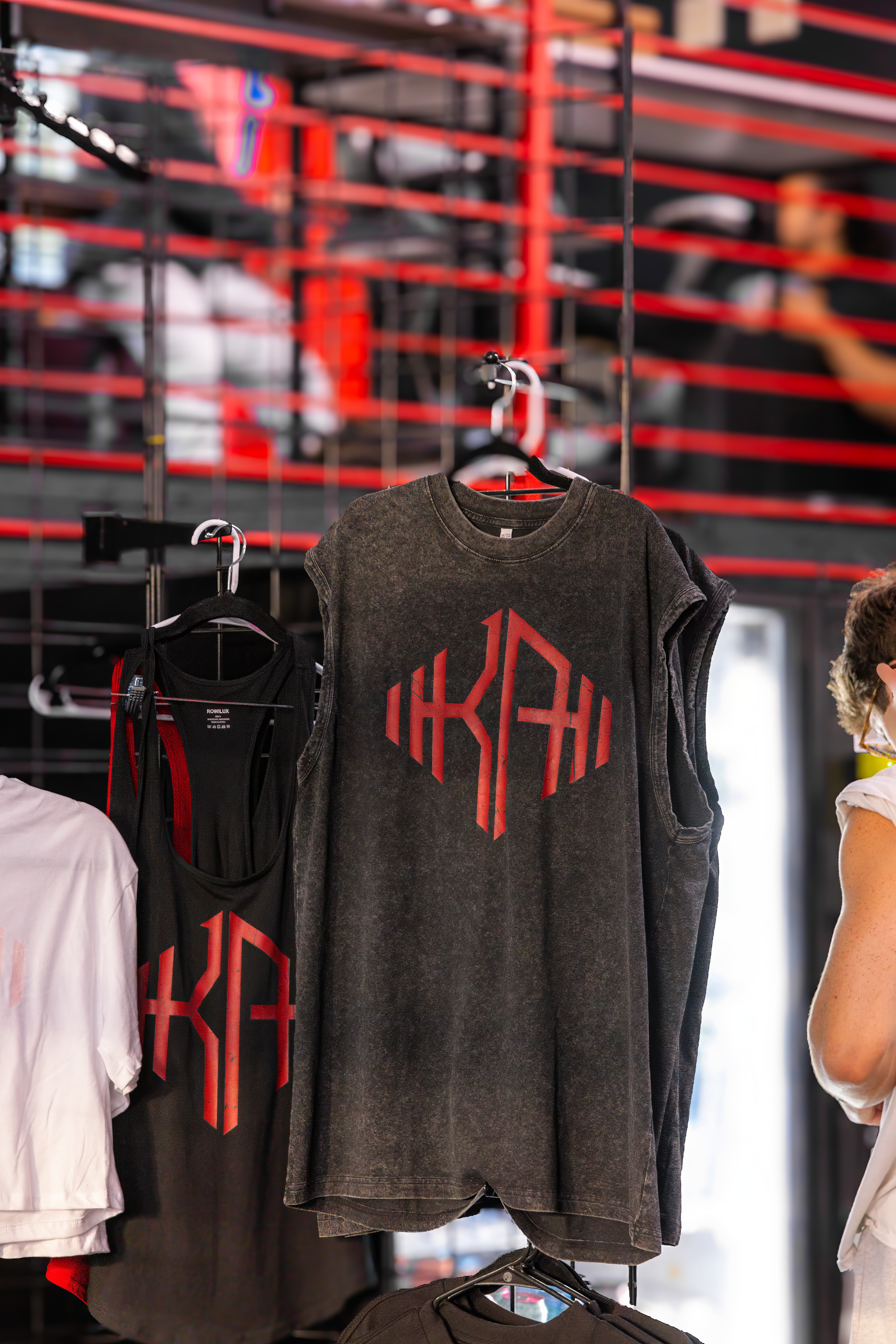 KlickWay Athletics branded apparel display, featuring a dark wash, sleeveless gym shirt with the distinctive red KWA logo